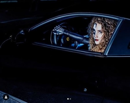 Sofie Dossi behind the wheel of Ferrari during the photoshoot. Know more about her net worth and relationship status